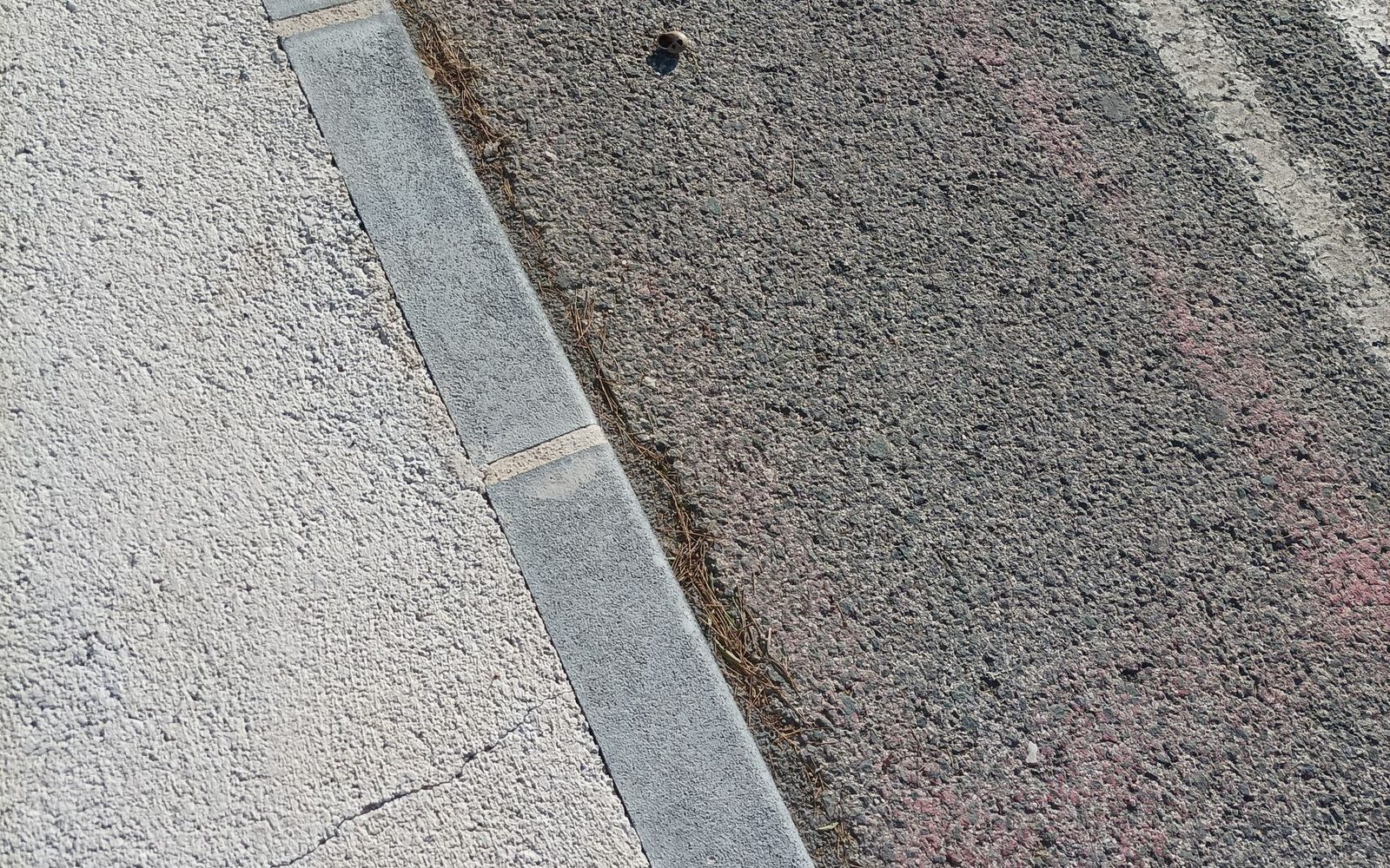 Concrete kerb line separating a footway from a road